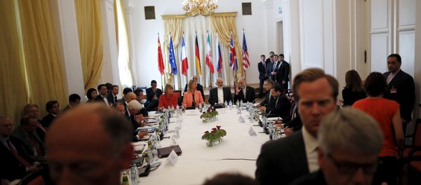 Iranian Foreign Minister Mohammad Javad Zarif (C) sits next to European Union High Representative for Foreign Affairs and Security Policy Federica Mogherini as they meet with foreign ministers from the U.S., France, Russia, Germany, China and Britain at the hotel where the Iran nuclear talks meetings are being held in Vienna, Austria July 6, 2015 Iranian Foreign Minister Mohammad Javad Zarif (C) sits next to European Union High Representative for Foreign Affairs and Security Policy Federica Mogherini as they meet with foreign ministers from the U.S., France, Russia, Germany, China and Britain at the hotel where the Iran nuclear talks meetings are being held in Vienna, Austria July 6, 2015 - Sputnik International