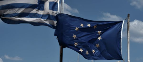 An EU and a Greek flag wave above the ancient temple of Parthenon atop the Acropolis hill in Athens on July 7, 2015 - Sputnik International