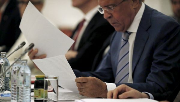 Russian Foreign Minister Sergei Lavrov reads documents during a meeting with foreign ministers and delegations from Germany, France, China, Britain, the U.S. and the European Union at a hotel in Vienna, Austria July 13, 2015 Russian Foreign Minister Sergei Lavrov reads documents during a meeting with foreign ministers and delegations from Germany, France, China, Britain, the U.S. and the European Union at a hotel in Vienna, Austria July 13, 2015 - Sputnik International