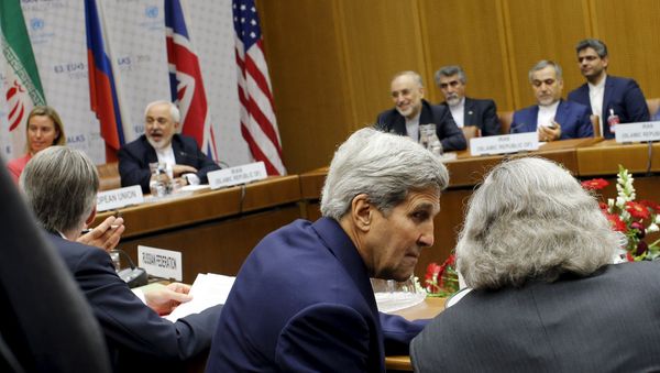 US Secretary of State John Kerry talks to U.S. Secretary of Energy Ernest Moniz (R) as Iranian Foreign Minister Mohammad Javad Zarif (2nd L) sits next to European Union High Representative for Foreign Affairs and Security Policy Federica Mogherini (L) during a plenary session at the United Nations building in Vienna, Austria July 14, 2015 US Secretary of State John Kerry talks to U.S. Secretary of Energy Ernest Moniz (R) as Iranian Foreign Minister Mohammad Javad Zarif (2nd L) sits next to European Union High Representative for Foreign Affairs and Security Policy Federica Mogherini (L) during a plenary session at the United Nations building in Vienna, Austria July 14, 2015 - Sputnik International
