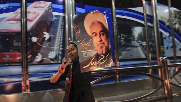 A supporter of moderate cleric Hassan Rouhani celebrates his victory - Sputnik International