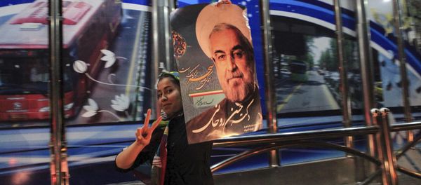 A supporter of moderate cleric Hassan Rouhani celebrates his victory - Sputnik International
