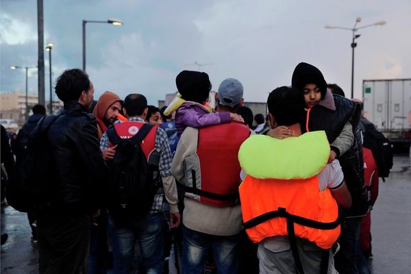 Temporary detained migrants walk at the port at Greek island of Kos Temporary detained migrants walk at the port at Greek island of Kos - Sputnik International