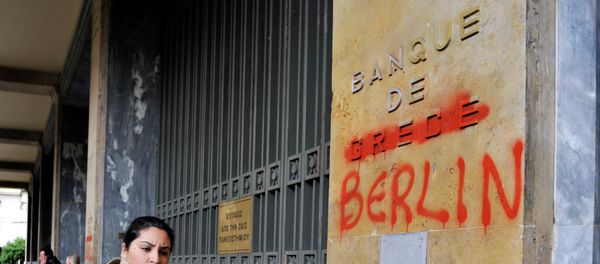 A woman passes by the Bank of Greece headquarters where 'Greece' was changed to 'Berlin' - Sputnik International