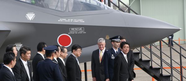 Japan's Prime Minister Shinzo Abe, right, looks at a mock-up of F-35 fighter jet. Japan's Prime Minister Shinzo Abe, right, looks at a mock-up of F-35 fighter jet. - Sputnik International