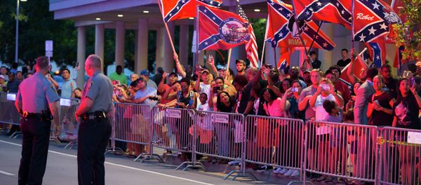 People wave Confederate flags outside the hotel that President Barack Obama is staying the night, on Wednesday, July 15, 2015, in Oklahoma City. Obama is traveling in Oklahoma to visit El Reno Federal Correctional Institution. People wave Confederate flags outside the hotel that President Barack Obama is staying the night, on Wednesday, July 15, 2015, in Oklahoma City. Obama is traveling in Oklahoma to visit El Reno Federal Correctional Institution. - Sputnik International