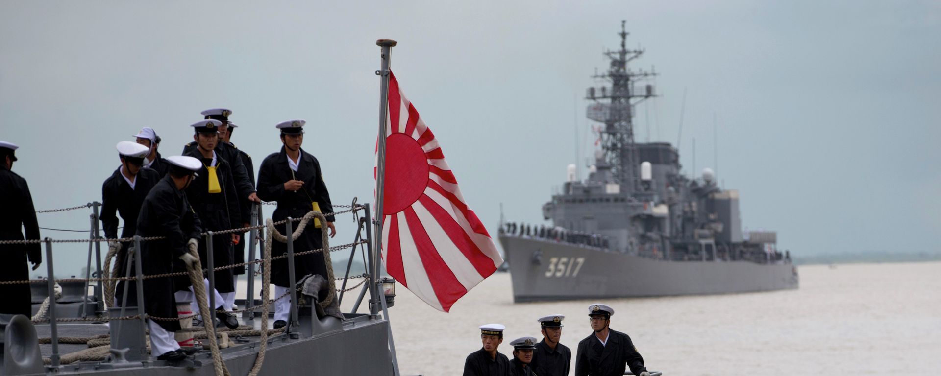 Japanese navy officers stand on the deck of Japan Maritime Self-Defense Force's vessel docked at Thilawa port, Myanmar, Monday, Sept. 30, 2013 - Sputnik International, 1920, 22.03.2026