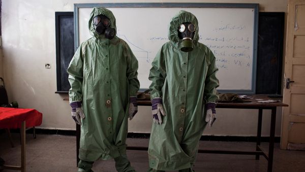 Volunteers wear protective gear during a class of how to respond to a chemical attack, in the northern Syrian city of Aleppo Volunteers wear protective gear during a class of how to respond to a chemical attack, in the northern Syrian city of Aleppo - Sputnik International