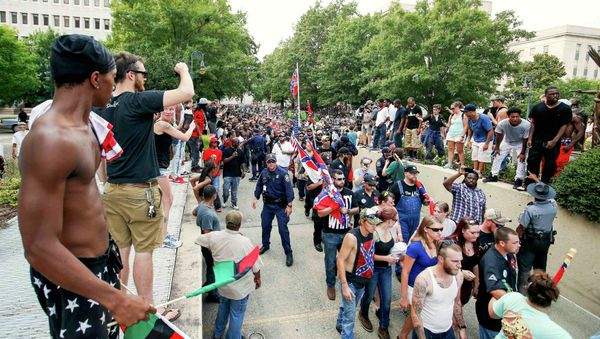 Protestors yell at the Ku Klux Klan as the march leaving a rally at the statehouse in Columbia, South Carolina July 18, 2015. Protestors yell at the Ku Klux Klan as the march leaving a rally at the statehouse in Columbia, South Carolina July 18, 2015. - Sputnik International