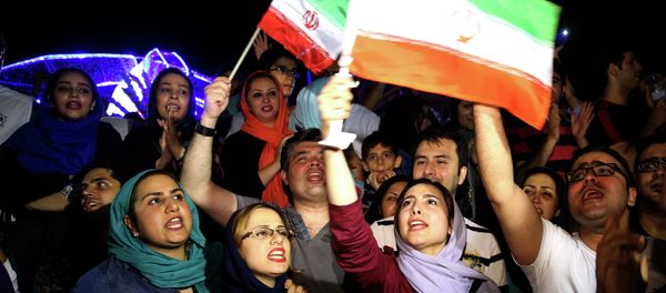 Jubilant Iranians sing and wave Iran flags during street celebrations following a landmark nuclear deal, in Tehran, Iran, Tuesday, July 14, 2015 Jubilant Iranians sing and wave Iran flags during street celebrations following a landmark nuclear deal, in Tehran, Iran, Tuesday, July 14, 2015 - Sputnik International