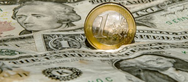 A one euro coin is pictured on one US dollar notes on March 13, 2015 in Godewaersvelde, Northern France - Sputnik International