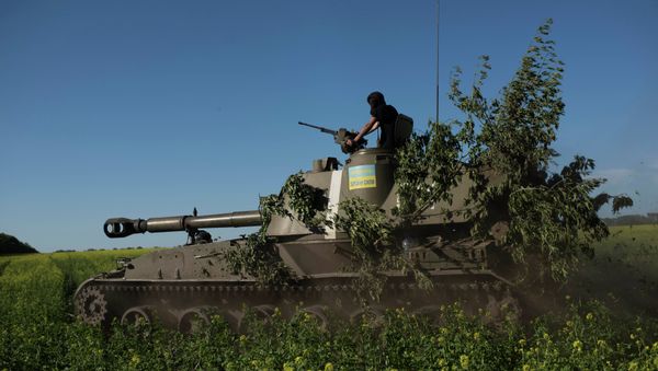A Ukrainian serviceman rides atop an armored military vehicle to take their positions near Donetsk, eastern Ukraine, Sunday, June 7, 2015 A Ukrainian serviceman rides atop an armored military vehicle to take their positions near Donetsk, eastern Ukraine, Sunday, June 7, 2015 - Sputnik International