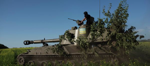 A Ukrainian serviceman rides atop an armored military vehicle to take their positions near Donetsk, eastern Ukraine, Sunday, June 7, 2015 - Sputnik International