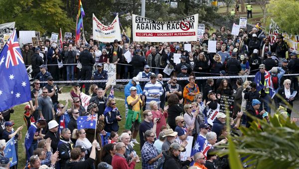 Opposing protest groups, from the Reclaim Australia anti-islam group (foreground) and those calling for an end to racism (background) are separated by a police line in Brisbane, July 19, 2015 - Sputnik International
