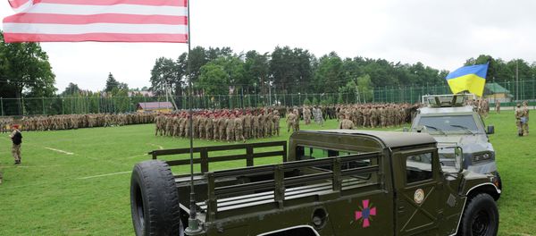 Ukrainian and US flags wave during the cermony of the drill opening in Yavoriv polygon, Lviv district, western Ukraine on July 20, 2015 - Sputnik International
