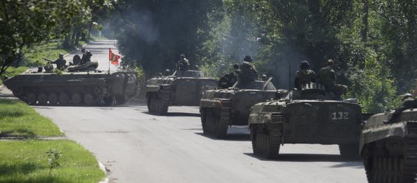 Members of the self-proclaimed Donetsk People's Republic forces ride on armoured personnel carriers (APC) near the urban settlement of Zaytsevo in Donetsk region, Ukraine, July 20, 2015 Members of the self-proclaimed Donetsk People's Republic forces ride on armoured personnel carriers (APC) near the urban settlement of Zaytsevo in Donetsk region, Ukraine, July 20, 2015 - Sputnik International