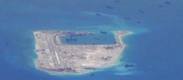 Chinese dredging vessels are purportedly seen in the waters around Fiery Cross Reef in the disputed Spratly Islands in the South China Sea in this still file image from video taken by a P-8A Poseidon surveillance aircraft provided by the United States Navy - Sputnik International