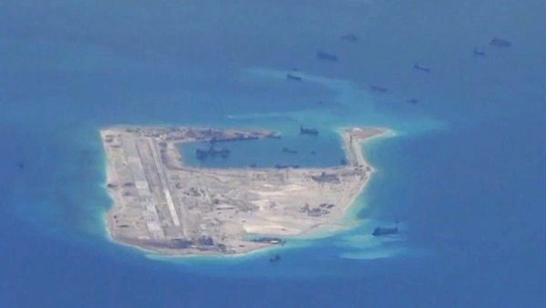 Chinese dredging vessels are purportedly seen in the waters around Fiery Cross Reef in the disputed Spratly Islands in the South China Sea in this still file image from video taken by a P-8A Poseidon surveillance aircraft provided by the United States Navy Chinese dredging vessels are purportedly seen in the waters around Fiery Cross Reef in the disputed Spratly Islands in the South China Sea in this still file image from video taken by a P-8A Poseidon surveillance aircraft provided by the United States Navy - Sputnik International
