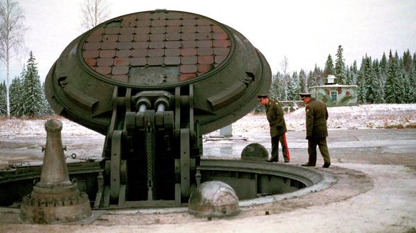 Russian high ranking military officials, look into an opened silo of a Russian intercontinental ballistic Topol-M missile somewhere at undisclosed location in Russia in this 2001 photo - Sputnik International