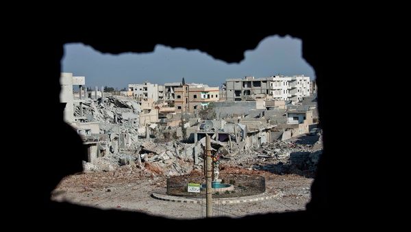 This Nov. 20, 2014 photo shows an area controlled by the Islamic State group, past the Qada Azadi roundabout, foreground, in Kobani, Syria. This Nov. 20, 2014 photo shows an area controlled by the Islamic State group, past the Qada Azadi roundabout, foreground, in Kobani, Syria. - Sputnik International
