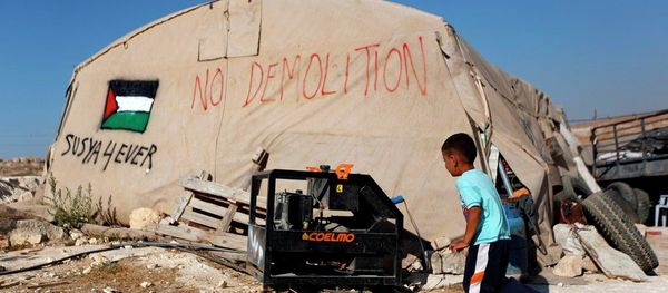 A Palestinian boy runs outside his family tent in the village of Susiya, south of the West Bank city of Hebron. A Palestinian boy runs outside his family tent in the village of Susiya, south of the West Bank city of Hebron. - Sputnik International