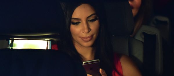 US reality TV star Kim Kardashian looks at her iPhone as she sits in a car after visiting the genocide memorial, which commemorates the 1915 mass killing of Armenians in the Ottoman Empire, in Yerevan on April 10, 2015 US reality TV star Kim Kardashian looks at her iPhone as she sits in a car after visiting the genocide memorial, which commemorates the 1915 mass killing of Armenians in the Ottoman Empire, in Yerevan on April 10, 2015 - Sputnik International