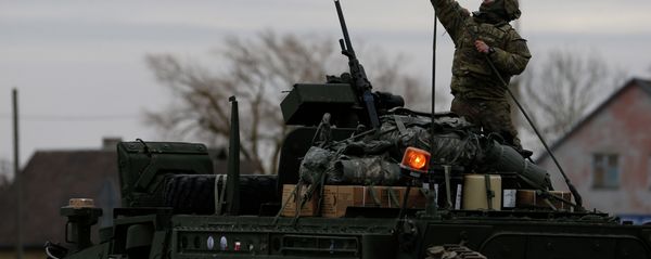 A member of US Army’s 2nd Cavalry Regiment raises the US flag on a Stryker vehicle during the ''Dragoon Ride'' military exercise, in Salociai some 178 kms (110 miles) north of the capital Vilnius, Lithuania, Monday, March 23, 2015 A member of US Army’s 2nd Cavalry Regiment raises the US flag on a Stryker vehicle during the ''Dragoon Ride'' military exercise, in Salociai some 178 kms (110 miles) north of the capital Vilnius, Lithuania, Monday, March 23, 2015 - Sputnik International