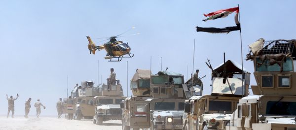 An Iraqi helicopter flies over military vehicles in Husaybah, in Anbar province July 22, 2015 An Iraqi helicopter flies over military vehicles in Husaybah, in Anbar province July 22, 2015 - Sputnik International