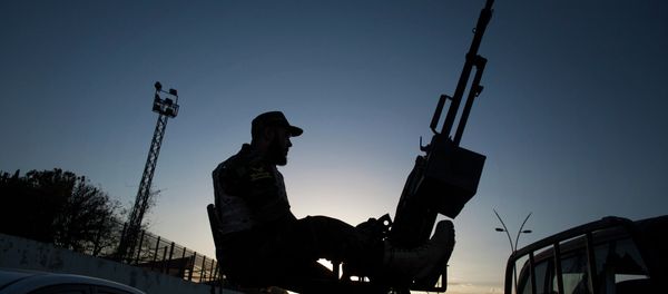A Libyan army soldier stands guard sitting on an antiaircraft truck during the handover of the Nawaseen military compound, which was the headquarters of Libyan militias, in Souk al-Juma district, Tripoli, Libya A Libyan army soldier stands guard sitting on an antiaircraft truck during the handover of the Nawaseen military compound, which was the headquarters of Libyan militias, in Souk al-Juma district, Tripoli, Libya - Sputnik International