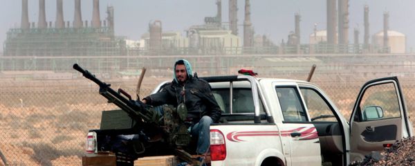 An anti-government rebel sits with an anti-aircraft weapon in front an oil refinery, after the capture of the oil town of Ras Lanouf, eastern Libya An anti-government rebel sits with an anti-aircraft weapon in front an oil refinery, after the capture of the oil town of Ras Lanouf, eastern Libya - Sputnik International