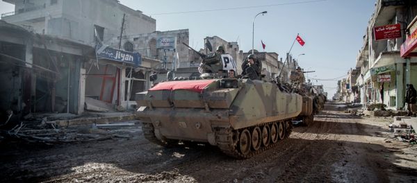 Turkish army vehicles drive in a street of the Syrian town of Kobane (aka Ain al-Arab) on February 22, 2015 Turkish army vehicles drive in a street of the Syrian town of Kobane (aka Ain al-Arab) on February 22, 2015 - Sputnik International
