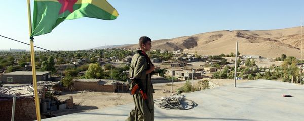 A Kurdistan Workers Party (PKK) fighters guards a post flying the PKK flag. File photo A Kurdistan Workers Party (PKK) fighters guards a post flying the PKK flag. File photo - Sputnik International