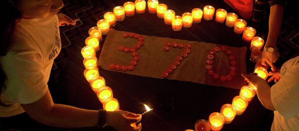 Relatives of Chinese passengers on board the Malaysia Airlines Flight MH370 light candles in a prayer room in Beijing, China, Friday, April 4, 2014. Relatives of Chinese passengers on board the Malaysia Airlines Flight MH370 light candles in a prayer room in Beijing, China, Friday, April 4, 2014. - Sputnik International