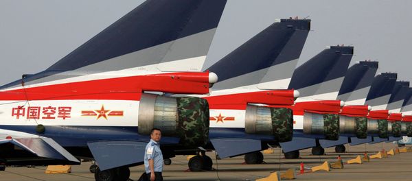 A man walks pasT the Chinese-made J-10 jet fighters on display at the 8th China International Aviation and Aerospace Exhibition (Zhuhai Airshow) in Zhuhai. - Sputnik International