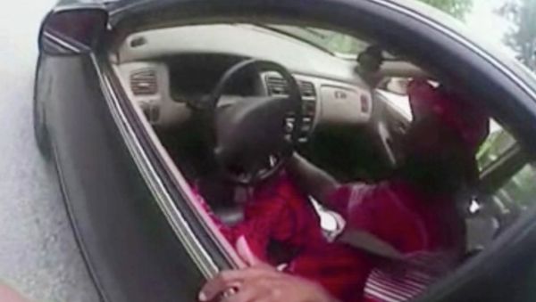 In this July 19, 2015 file photo from a body camera video provided by the University of Cincinnati Campus Police, university Officer Ray Tensing stands next to motorist Samuel DuBose during a traffic stop for a missing front license plate in Cincinnati. DuBose was fatally shot by the officer after a struggle ensued when he refused to provide a driver's license and get out of the car. Tensing was indicted Wednesday, July 29 on a murder charge. - Sputnik International