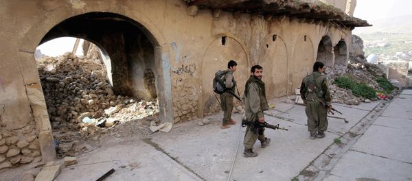 In this Thursday Jan. 29, 2015 photo, fighters of the Turkey-based Kurdish Workers' Party (PKK) walk in the damaged streets of Sinjar, Iraq In this Thursday Jan. 29, 2015 photo, fighters of the Turkey-based Kurdish Workers' Party (PKK) walk in the damaged streets of Sinjar, Iraq - Sputnik International