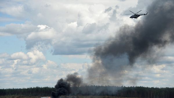 Firefighters extinguish fire at the crash site of a MI-28 helicopter at Dubrovichi base, Ryazan Region - Sputnik International