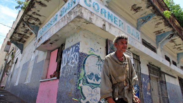 A homeless man stands in front of a closed down business in Puerta de Tierra in the outskirts of Old San Juan, Puerto Rico, Sunday, Aug. 2, 2015. Mired in a 10 year old economic crisis, Puerto Rico failed to pay a $58 million bond payment due Saturday. If defaults continue, analysts say Puerto Rico will face numerous lawsuits and increasingly limited access to markets, putting a recovery even more out of reach. - Sputnik International
