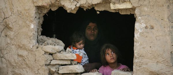Iraqi family stands inside their home hit by an airstrike in Fidhailiya area in eastern Baghdad, Iraq. Iraqi family stands inside their home hit by an airstrike in Fidhailiya area in eastern Baghdad, Iraq. - Sputnik International