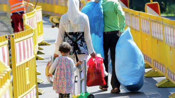 Asylum seekers walk outside the central refugee camp in Giessen, Germany, Monday, Aug. 3, 2015. Asylum seekers walk outside the central refugee camp in Giessen, Germany, Monday, Aug. 3, 2015. - Sputnik International