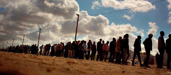 Migrants line up as the wait for a food ration distributed by the Banque Alimentaire of Calais at a camp in northern France, Tuesday, Aug. 4, 2015. - Sputnik International
