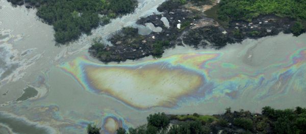Oil is seen on the creek water's surface near an illegal oil refinery in Ogoniland, outside Port Harcourt. File photo Oil is seen on the creek water's surface near an illegal oil refinery in Ogoniland, outside Port Harcourt. File photo - Sputnik International
