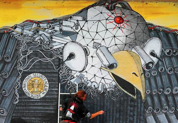 Artist A. Signl, of the artist group Captain Borderline paints the mural 'Surveillance of the fittest' at a wall in Cologne, Germany, Thursday, Oct. 24, 2013.  - Sputnik International