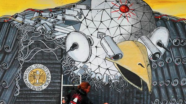 Artist A. Signl, of the artist group Captain Borderline paints the mural 'Surveillance of the fittest' at a wall in Cologne, Germany, Thursday, Oct. 24, 2013.  - Sputnik International