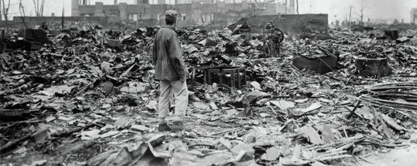 An allied correspondent stands in the rubble in front of the shell of a building that once was a movie theater in Hiroshima, Japan, a month after the first atomic bomb ever used in warfare was dropped by the U.S. on Aug. 6, 1945 - Sputnik International