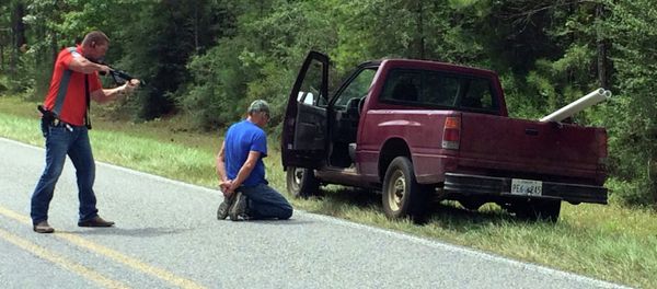 A Mississippi Bureau of Investigation agent detains a person of interest after shots were reportedly fired a second consecutive day Wednesday near Camp Shelby, Mississippi. A Mississippi Bureau of Investigation agent detains a person of interest after shots were reportedly fired a second consecutive day Wednesday near Camp Shelby, Mississippi. - Sputnik International