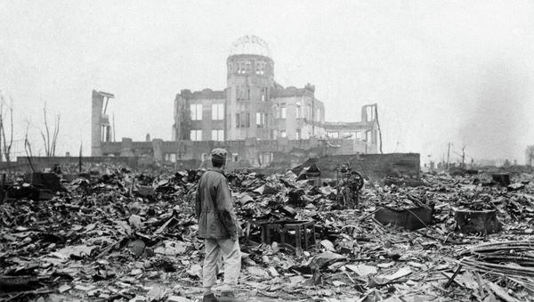 This Sept. 8, 1945 picture shows an allied correspondent standing in the rubble in front of the shell of a building This Sept. 8, 1945 picture shows an allied correspondent standing in the rubble in front of the shell of a building - Sputnik International