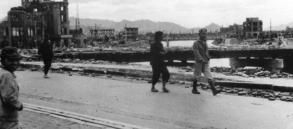 Local residents walk past the gutted Hiroshima Prefectural Industrial Promotion Hall - Sputnik International