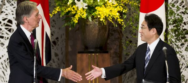 Japan's Foreign Minister Fumio Kishida (R) shakes hands with British Foreign Secretary Philip Hammond after a news conference about the 4th UK-Japan Strategic Dialogue at Iikura House in Tokyo - Sputnik International