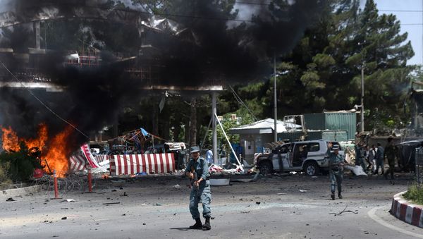 An Afghan policeman keeps watch at the site of a powerful truck bomb in Kabul on August 10, 2015 An Afghan policeman keeps watch at the site of a powerful truck bomb in Kabul on August 10, 2015 - Sputnik International